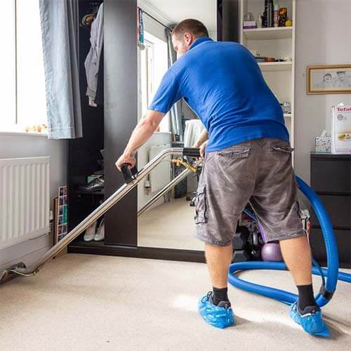 professional and thoroughcarpet cleaning - man cleaning carpet using commercial machinery - carpet hard floor cleaning in Norwich and Norfolk